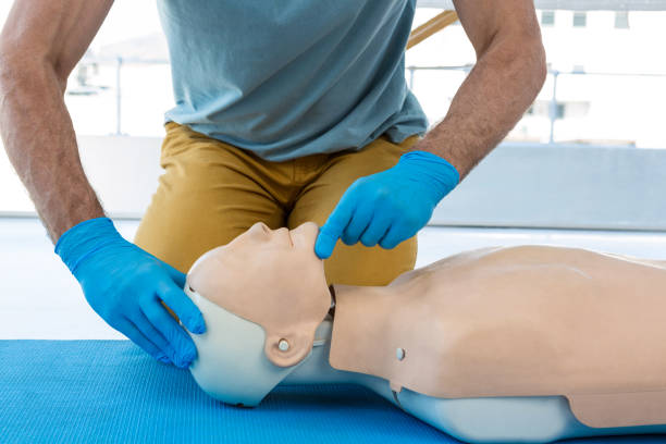 istock Mid section of paramedic practising resuscitation on dummy 653874876