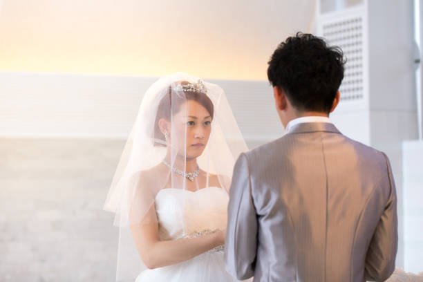 istock Happy groom giving wedding ring to bride 653874988