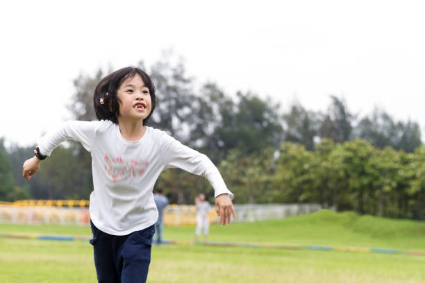 istock Little girl dancing in park. 653875606
