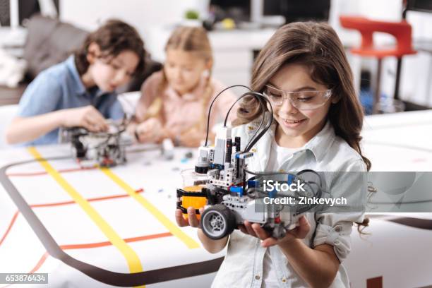 Lovely Little Girl Holding Robot At School Stock Photo - Download Image Now - Child, Robot, Robotics