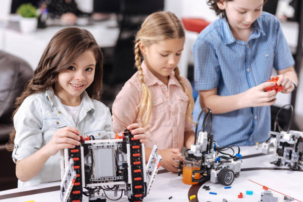 istock Hilarious school children enjoying science lesson at school 653876518