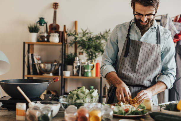 istock Smiling chef mixing meat and mustard 653880004