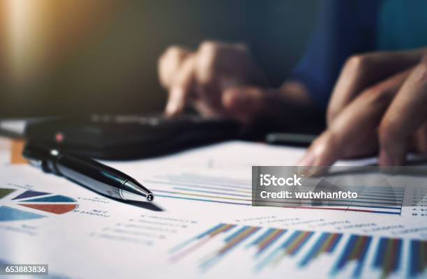 Close Up Pen On Paperwork And Woman Hand Calculate Finance Stock Photo - Download Image Now