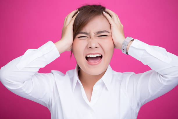 istock Angry woman screaming out and pulling her hair 653884958