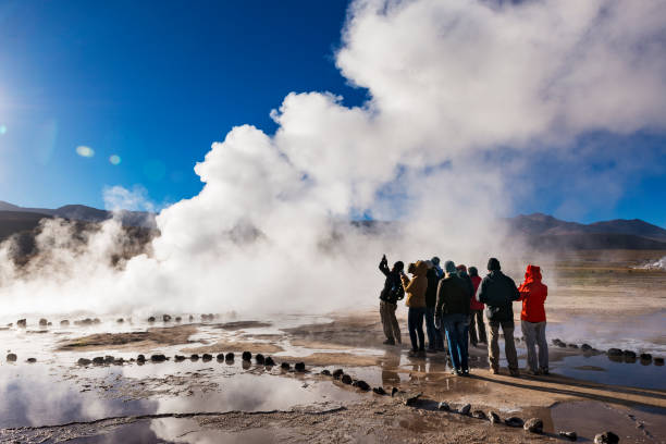 Tourists watching a geyser in the Geysers del Tatio field in the Atacama Desert, Northern Chile Geysers del Tatio, Chile - November 24, 2013: Tourists watching a geyser in the Geysers del Tatio field in the Atacama Desert, Northern Chile chile tourist stock pictures, royalty-free photos & images