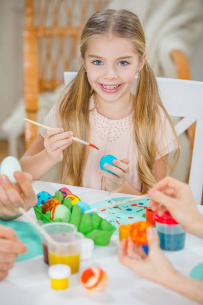 istock Girl painting Easter eggs 653886652