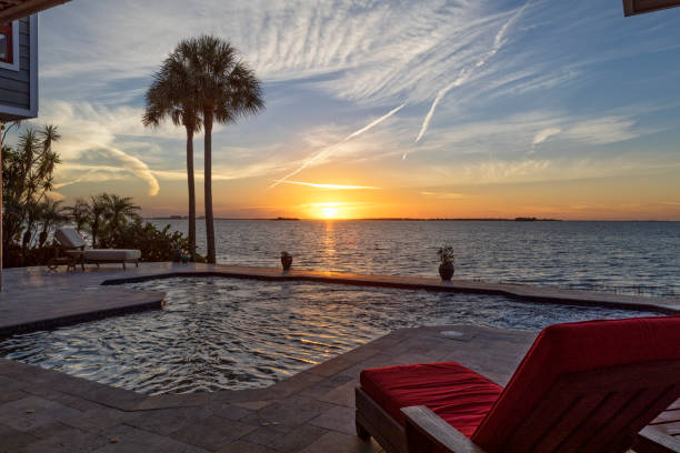 istock Beautiful Evening by the Swimming Pool in Tropical Setting 653891188
