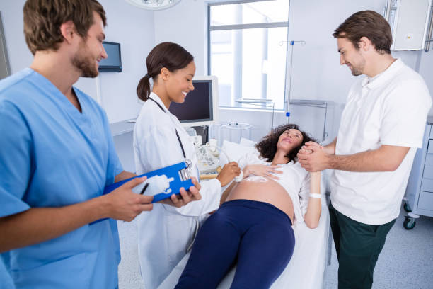 istock Doctor interacting with pregnant woman while doing ultrasound scan 653893368