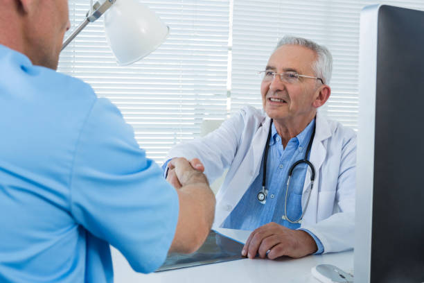 istock Doctor and surgeon shaking hands 653893578