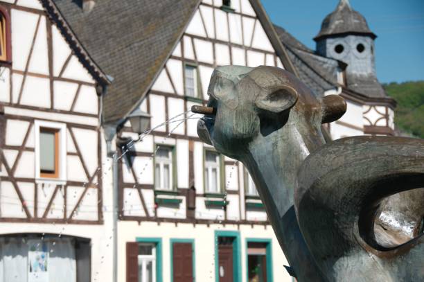 tatzelwurm fuente estatua con una vieja casa half-timbered en kobern-gondorf, alemania - lindworm fotografías e imágenes de stock
