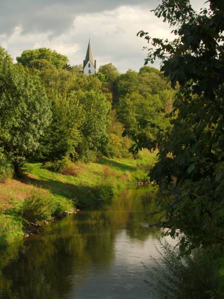istock View on the river Nidda and the oldest church (Auferstehungskirche) of Bad Vilbel, Germany 653893708
