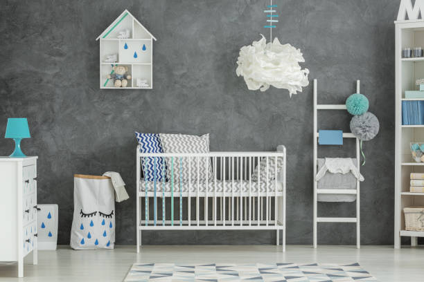 istock Grey baby bedroom with cot 653894516