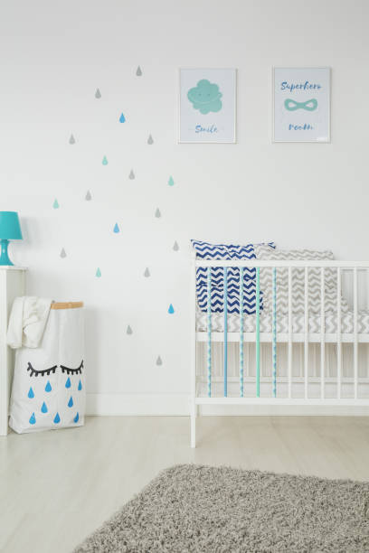 istock Simple, white baby bedroom 653894544