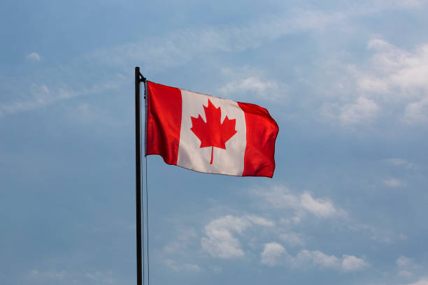 istock National flag of Canada on a flagpole 653897230