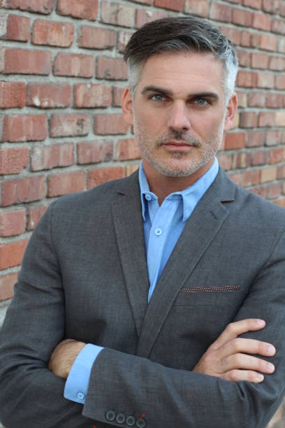 istock Good looking businessman with arms crossed 653898360