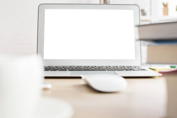istock Wooden desktop with white laptop 653903454