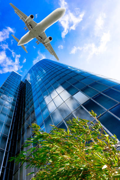 istock Skyscrapers with a flying airplane against blue sky 653903938