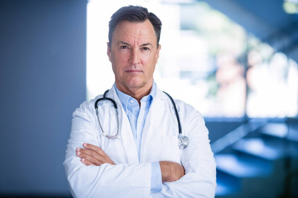 Portrait of doctors standing with arms crossed stock photo