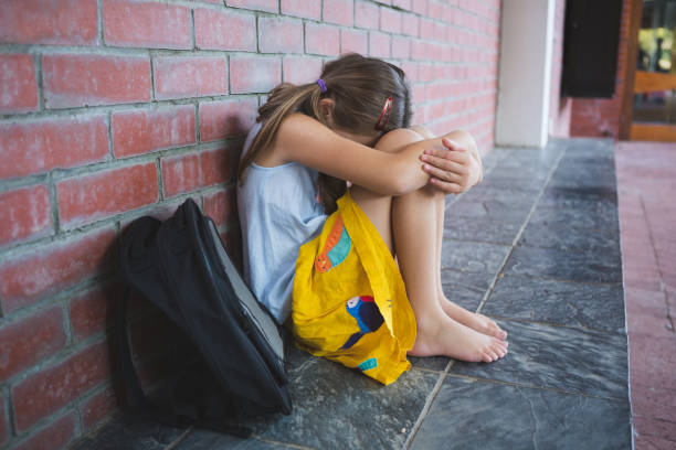 istock Sad schoolkid sitting alone in corridor 653910628