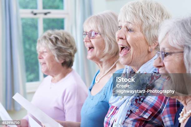 Group Of Senior Women Singing In Choir Together Stock Photo - Download Image Now - Singing, Choir, Senior Adult