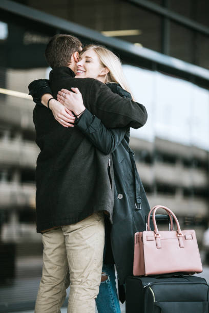 istock Couple Hug at Airport Arrival Area 653914862