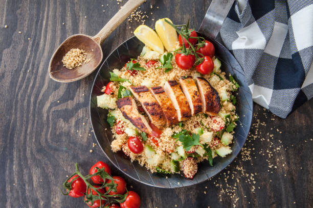 Couscous with haehnchenbruts Couscous with tomato and cucumber and grilled chicken breast couscous stock pictures, royalty-free photos & images