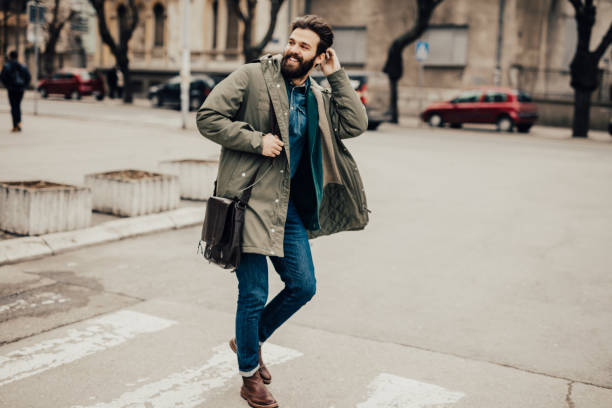 istock Attractive young fellow walking down the street 653919588