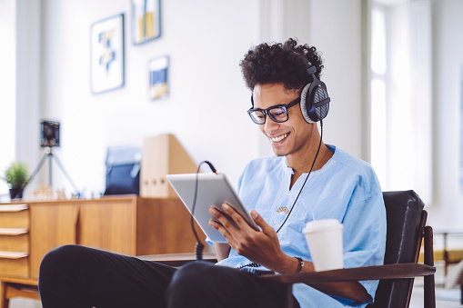 Young man is listening music at home