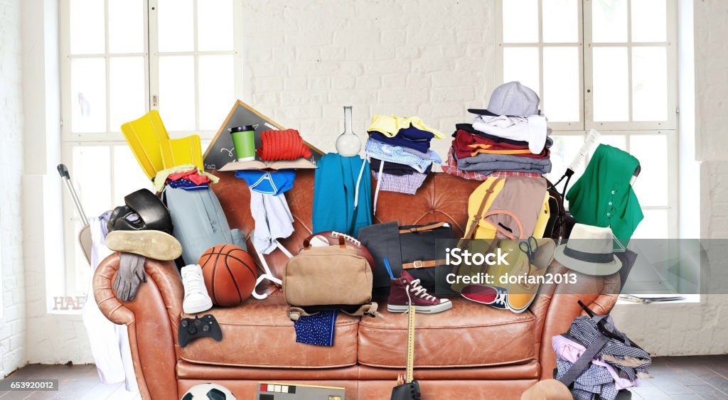 Large leather sofa Large leather sofa with a bunch of different things Messy Stock Photo