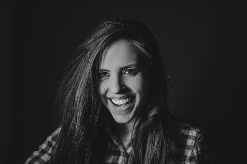 Black and white photo of gorgeous young woman with beautiful smile