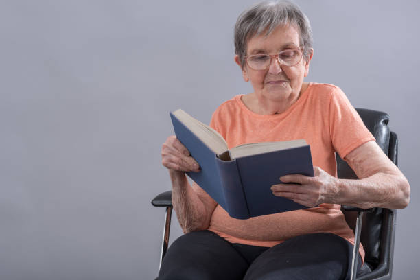 istock Senior woman reading a book 653925704