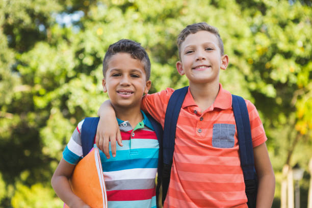 istock Smiling schoolkids standing in campus 653927444
