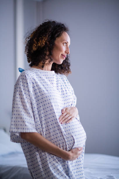 istock Thoughtful pregnant woman standing in ward 653927820