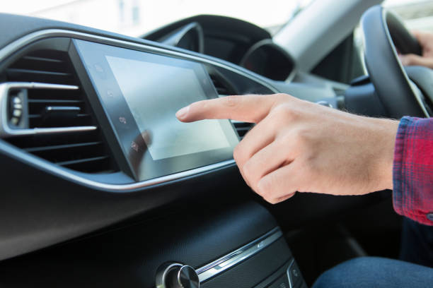 istock Close Up Of Driver Using Touchscreen In Car 653929060