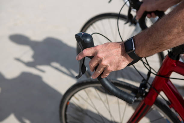 istock Close-up of mans hand wearing smartwatch while riding bicycle 653930226