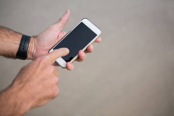 istock Close-up of mans hands using mobile phone 653931604