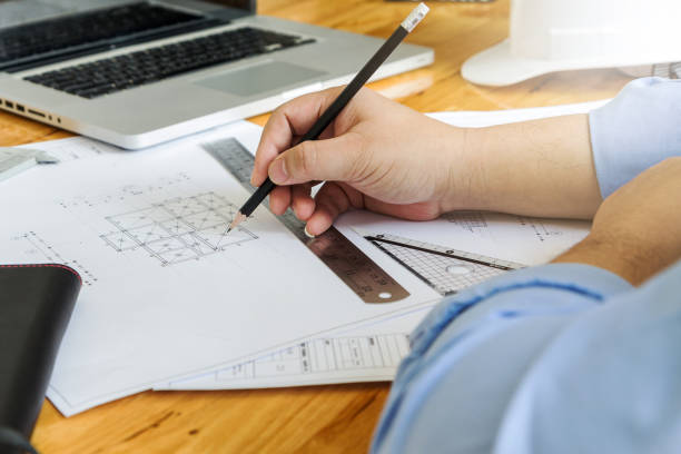istock Businessman holding a pencil for working on his job 653932458