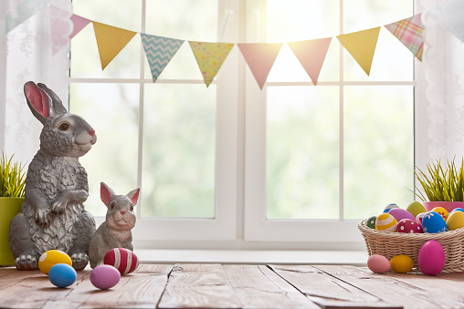 Happy Easter! Background with colorful eggs in basket. Table decorating for holiday.