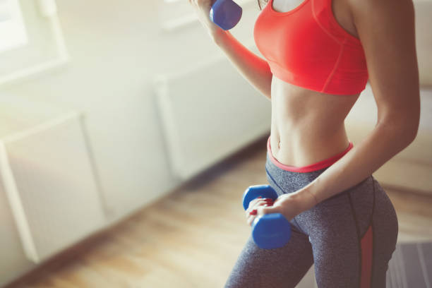 istock Fit sportswoman exercising and training at home 653934240