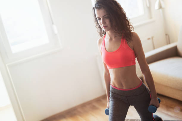 istock Fit sportswoman exercising and training at home 653934496