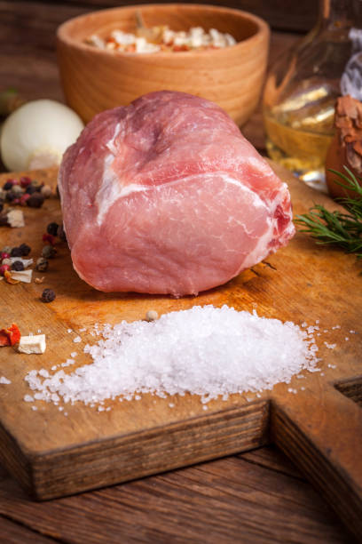 istock Piece of pork on a wooden board. 653937898