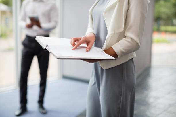 istock Businesswoman holding a file at conference centre 653941304