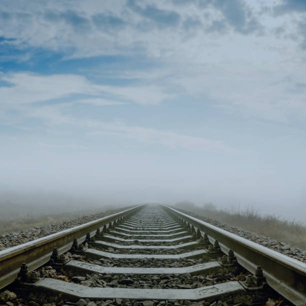 istock railroad in fog to horizon. soft focus 653943138
