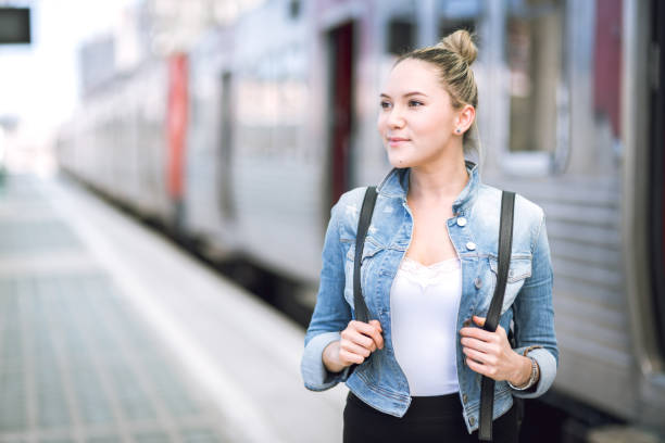istock Woman traveler with backpack on rail station 653943372