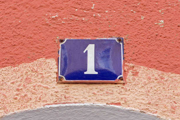 istock House number - White 1 on old-fashioned blue enamel sign 653944826