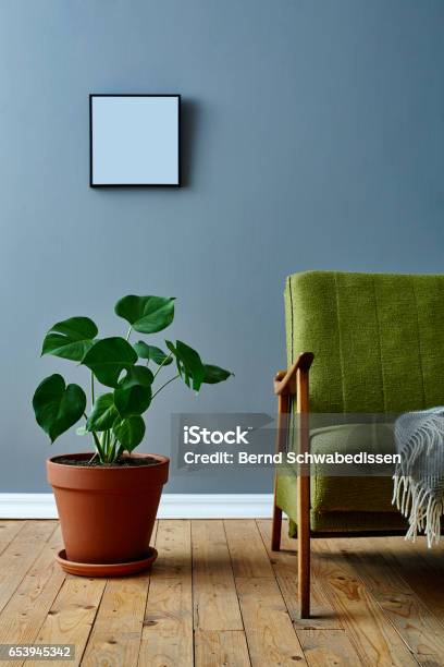 Monstera Plant And Vintage Easy Chair In Loft Atmosphere Stock Photo - Download Image Now