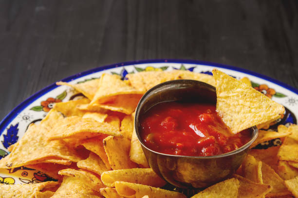 istock Tortilla chips on a blue plate with spicy tomato salsa. Mexican 653945496