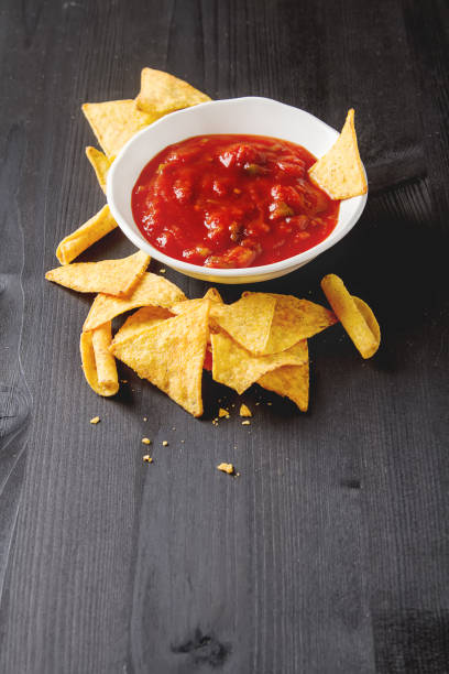 istock Tortilla chips on a blue plate with spicy tomato salsa. Mexican 653945566