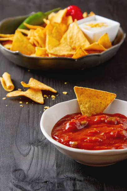 istock Tortilla chips on a blue plate with spicy tomato salsa. Mexican 653945576