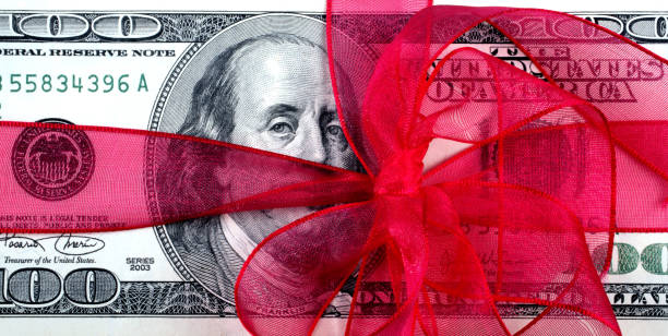 istock dollar bill background with ribbon 653947978